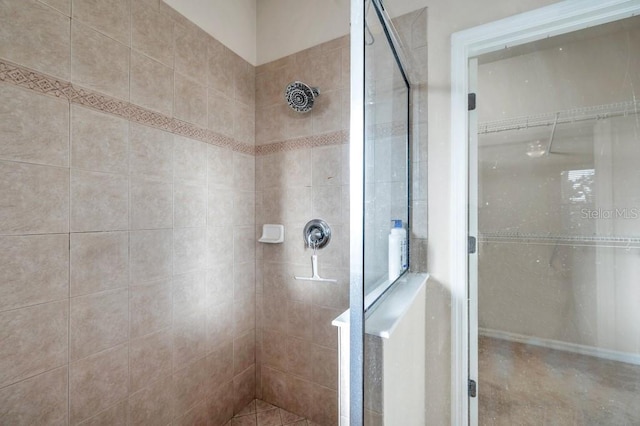 bathroom with a tile shower