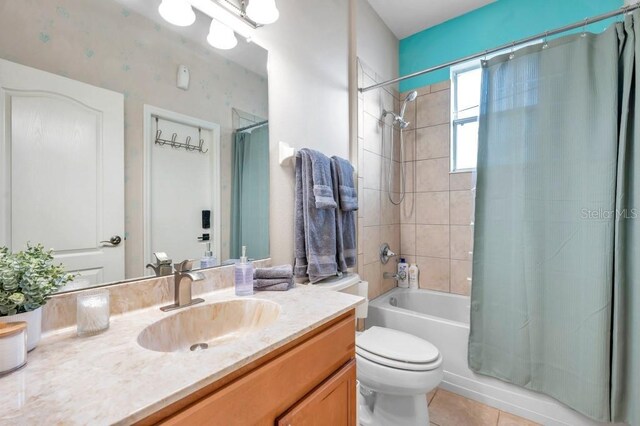 bathroom featuring tile patterned flooring, vanity, and toilet