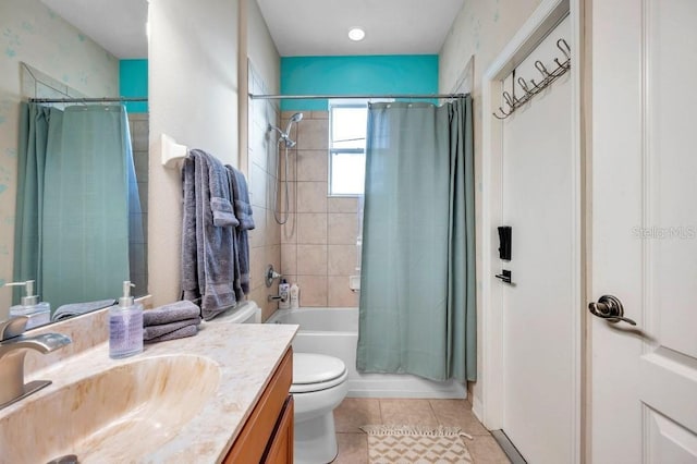 full bathroom featuring tile patterned flooring, vanity, toilet, and shower / bathtub combination with curtain