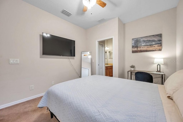 bedroom with ensuite bath, ceiling fan, and light carpet