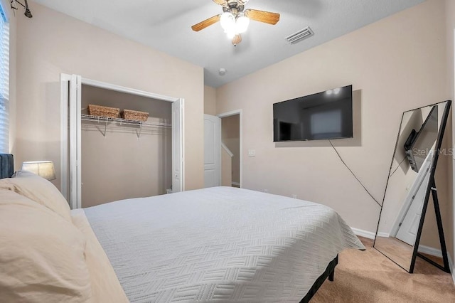 carpeted bedroom featuring ceiling fan and a closet