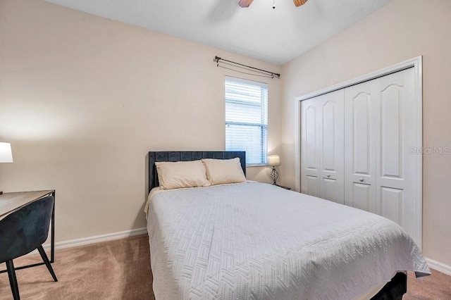 carpeted bedroom featuring ceiling fan and a closet