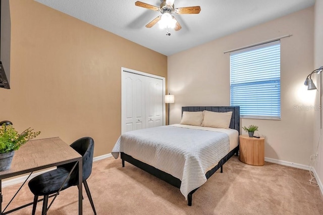 carpeted bedroom featuring a closet and ceiling fan