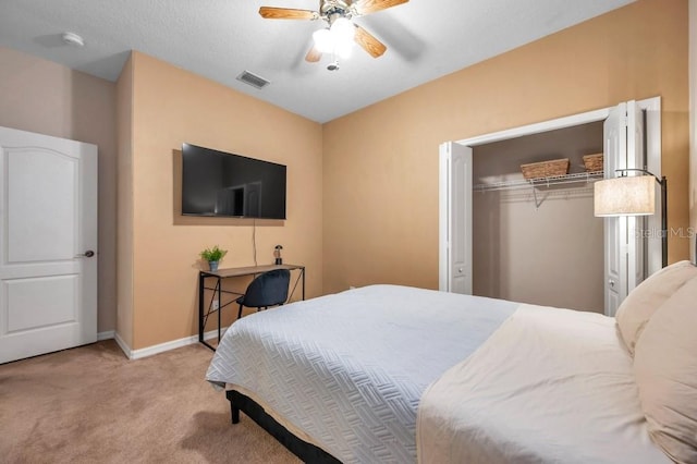 bedroom featuring ceiling fan, a closet, and light colored carpet