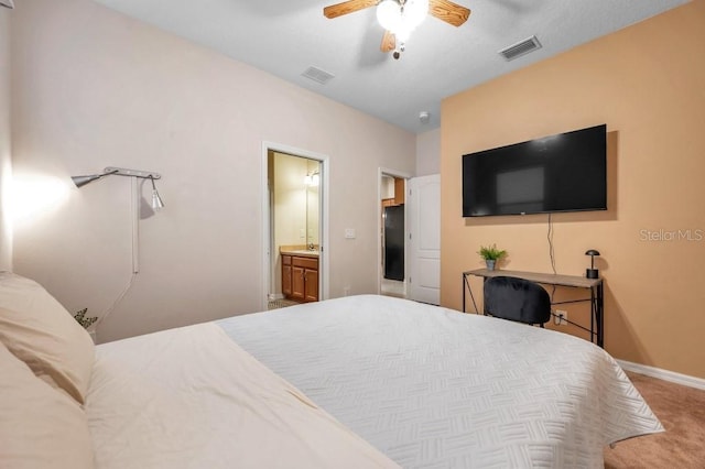 bedroom with light carpet, black fridge, ensuite bath, and ceiling fan