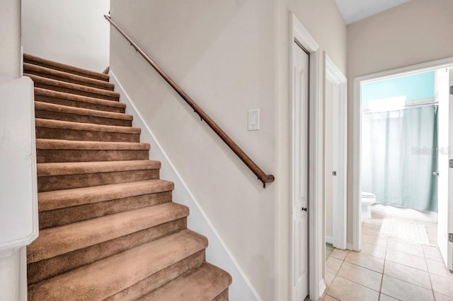 stairs featuring tile patterned floors