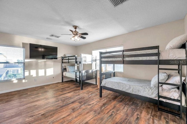 bedroom with ceiling fan and dark wood-type flooring