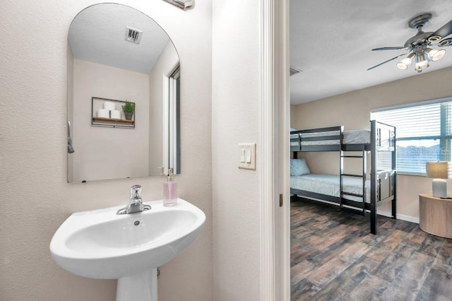 bathroom with ceiling fan, sink, and wood-type flooring