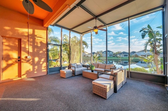 sunroom with ceiling fan, a healthy amount of sunlight, a water view, and beam ceiling