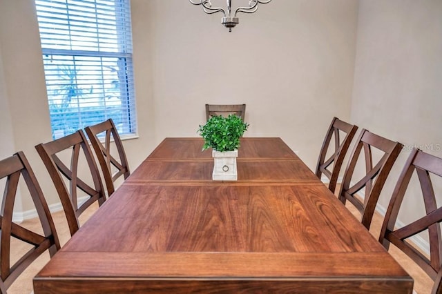 dining area featuring a notable chandelier