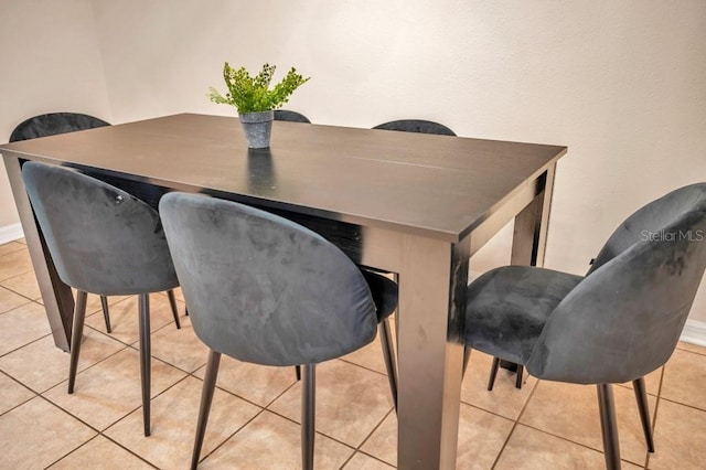 dining space featuring light tile patterned floors