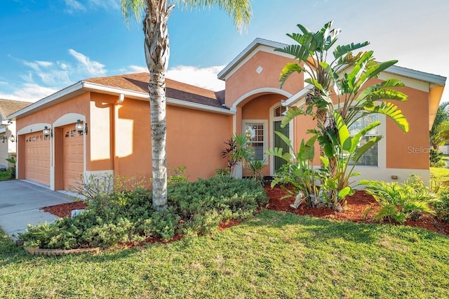 view of front of home featuring a garage and a front lawn