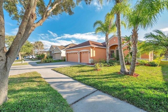 view of front of house with a garage and a front lawn