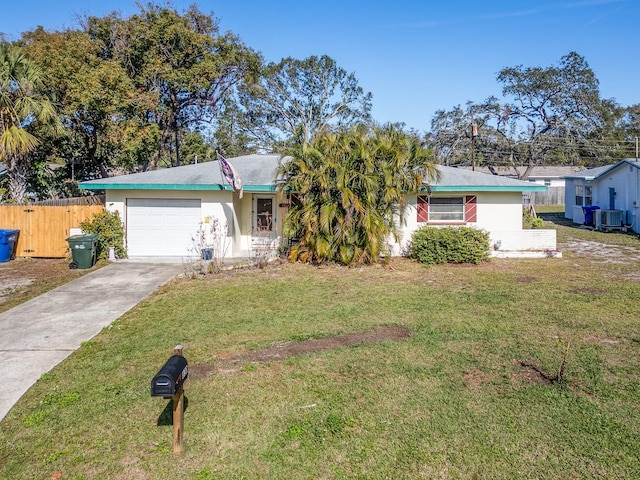 single story home featuring central air condition unit, a front yard, and a garage