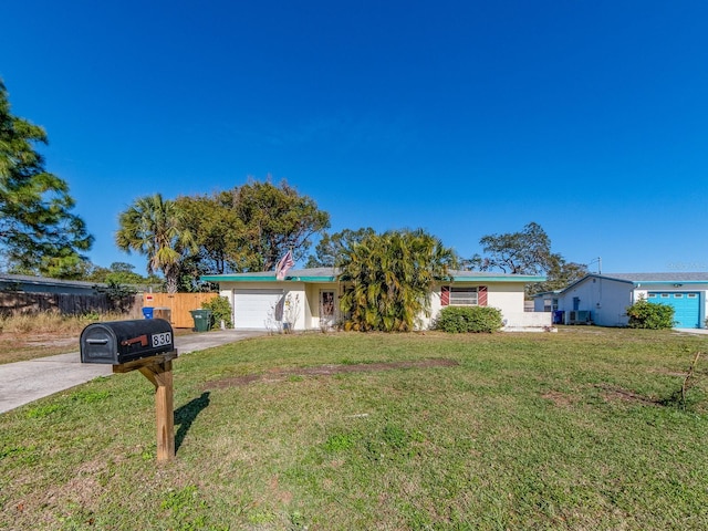 ranch-style house with a garage and a front lawn