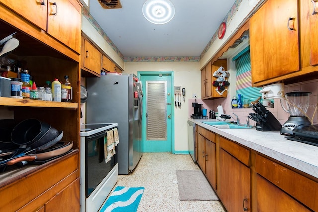 kitchen with range, stainless steel dishwasher, and sink