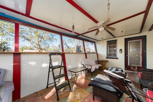 sunroom / solarium with a wealth of natural light and ceiling fan