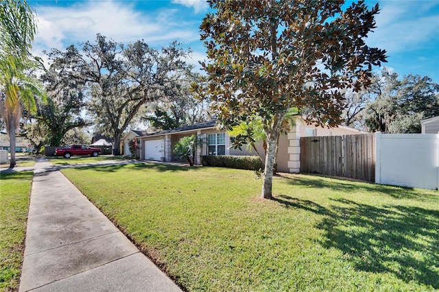 view of front facade featuring a front yard and a garage