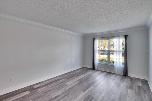 spare room with wood-type flooring, a textured ceiling, and crown molding