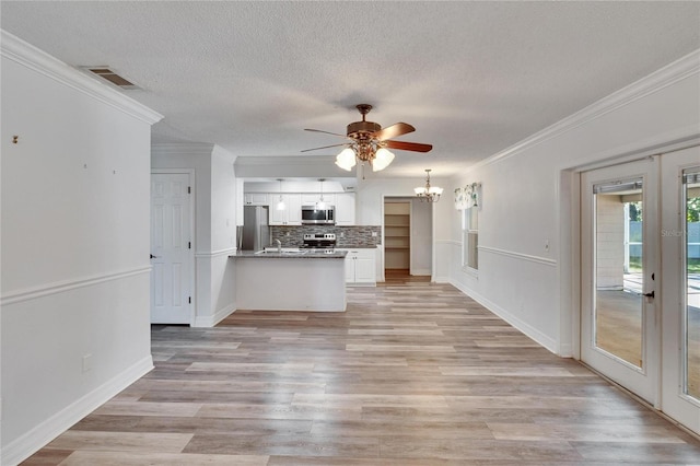 unfurnished living room featuring crown molding, french doors, light hardwood / wood-style floors, and ceiling fan with notable chandelier