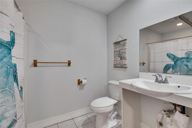 bathroom with sink, tile patterned flooring, a shower with shower curtain, and toilet