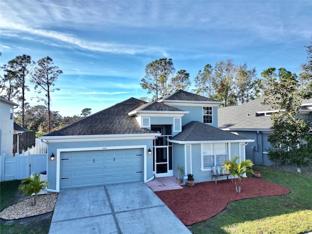 view of front property featuring a garage and a front lawn