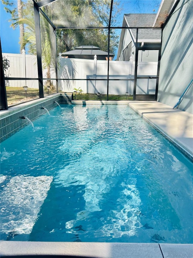 view of pool featuring a lanai and pool water feature