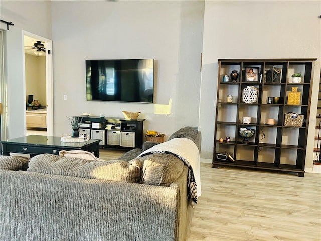 living room with hardwood / wood-style floors and ceiling fan