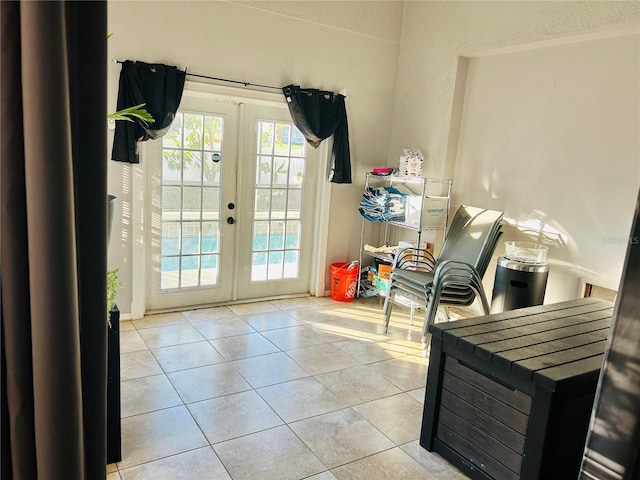 entryway with french doors and light tile patterned floors