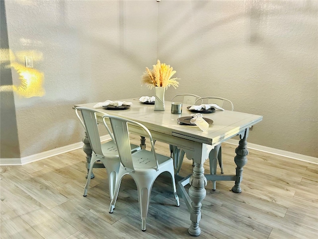 dining space with light wood-type flooring