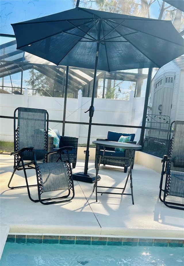 view of patio featuring pool water feature, a storage unit, and a fenced in pool