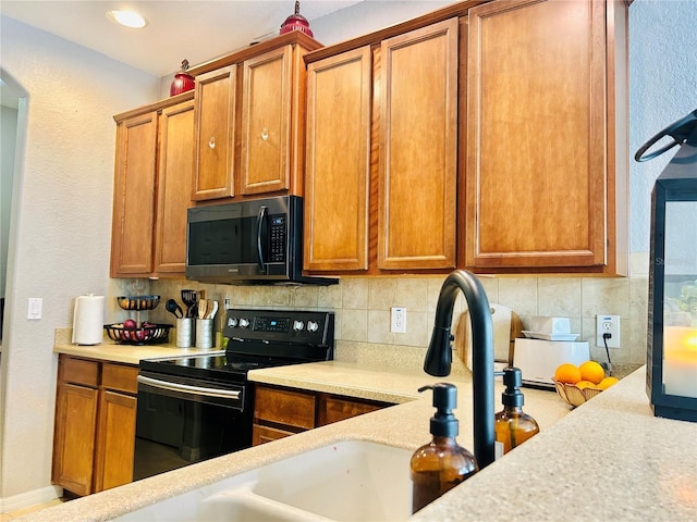 kitchen featuring backsplash and black / electric stove