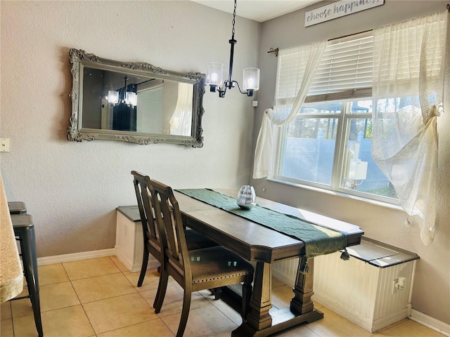 tiled dining space featuring an inviting chandelier