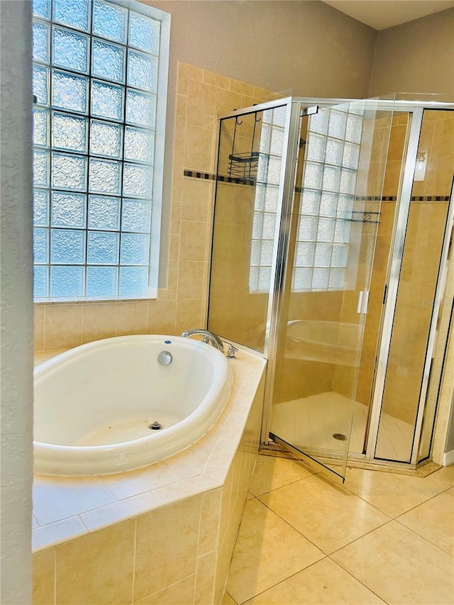 bathroom featuring tile patterned floors and separate shower and tub