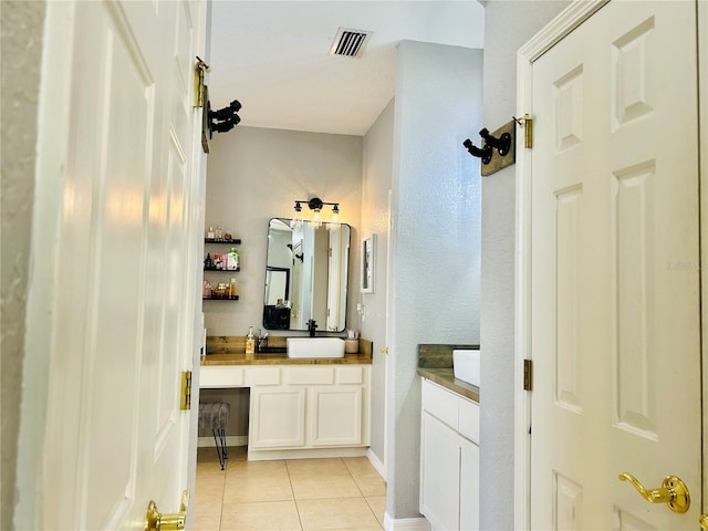 bathroom with tile patterned flooring and vanity