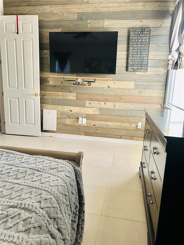 tiled bedroom featuring wood walls