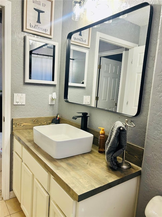 bathroom with tile patterned flooring and vanity