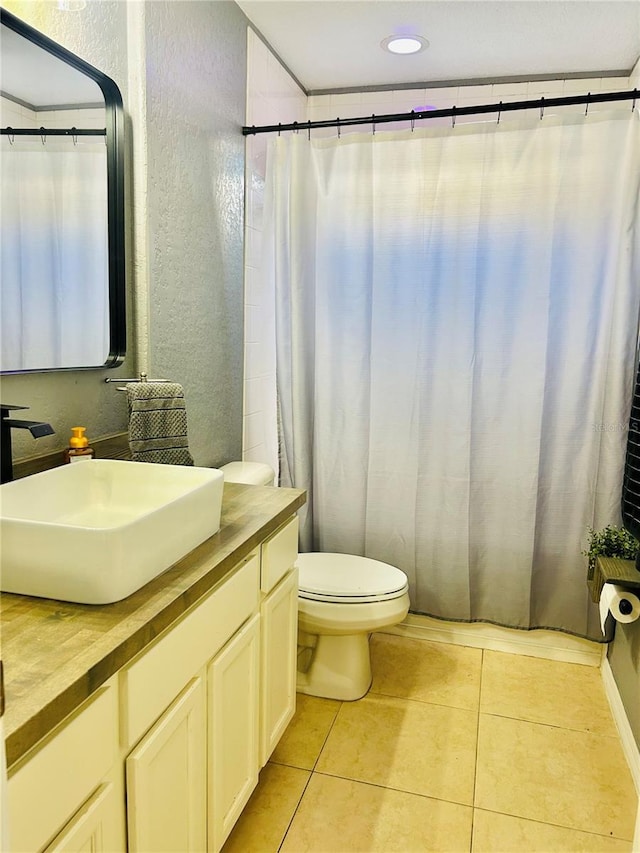 bathroom with tile patterned floors, vanity, and toilet