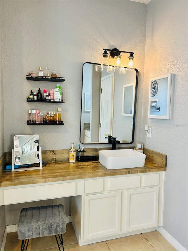 bathroom with tile patterned floors and vanity