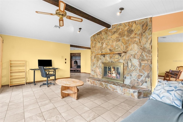 living room featuring tile patterned flooring, vaulted ceiling with beams, a stone fireplace, and ceiling fan