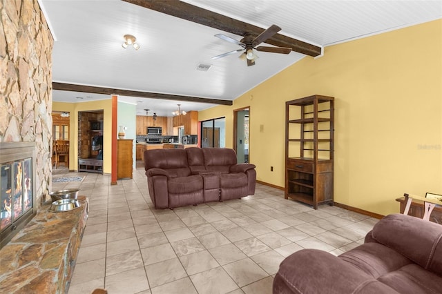 living room with a fireplace, light tile patterned floors, lofted ceiling with beams, and ceiling fan with notable chandelier