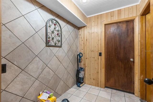 bathroom with wooden walls, tile patterned floors, and crown molding