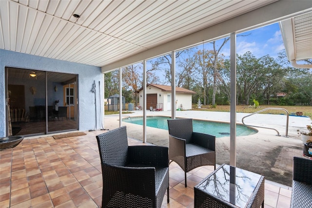 view of swimming pool with a patio area and an outbuilding