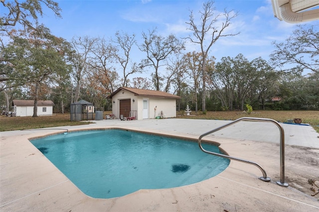 view of swimming pool featuring a patio and an outdoor structure