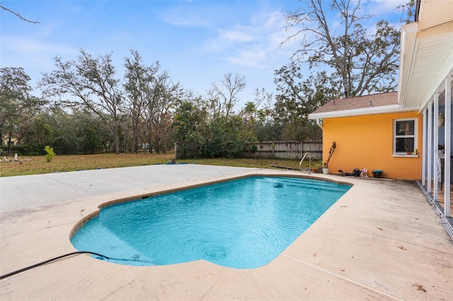 view of pool featuring a lawn and a patio area