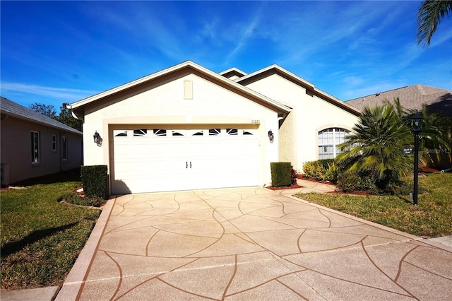 single story home with a garage and a front lawn