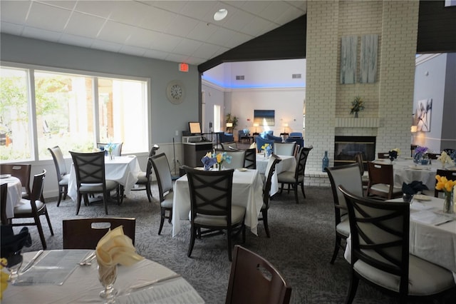 dining area with a fireplace and carpet