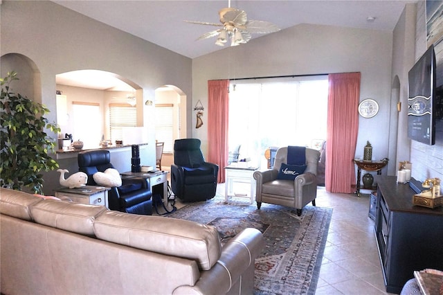 living room with tile patterned floors, ceiling fan, a healthy amount of sunlight, and lofted ceiling