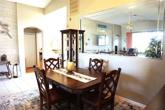 dining room with tile patterned flooring, ceiling fan, and vaulted ceiling