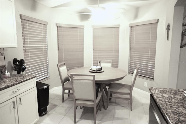 tiled dining space with ceiling fan